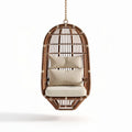 Hanging rattan chair with removable cushions for indoor and outdoor use